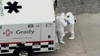 Kent Brantly, dressed in protective clothing, arriving at Emory University Hospital