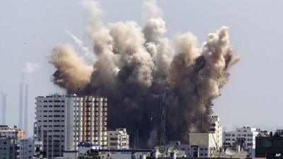 Smoke, dust and debris rise over Gaza City after an Israeli strike.