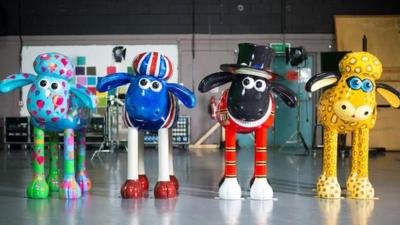 Four customised Shaun sculptures