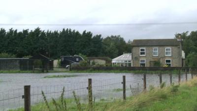 Fenland house surrounded by floodwater