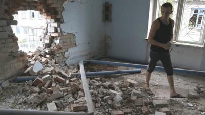 Prison inmate next to shell damage