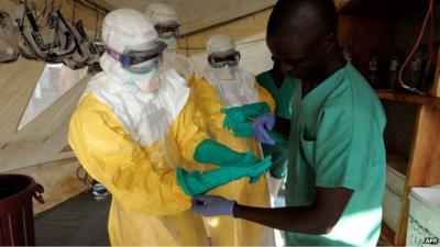 People wearing protective clothing in a West African country affected by the outbreak