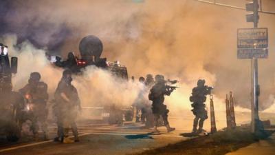 Police in Ferguson fire tear gas amid a tense stand-off with protesters