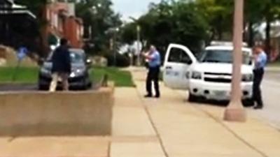 Police point their weapons at a robbery suspect