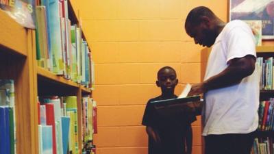 A father and son in a library