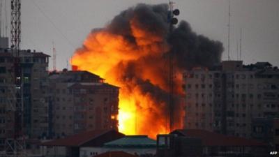 Ball of fire rises from a building following an Israeli air strike in Gaza City on August 23