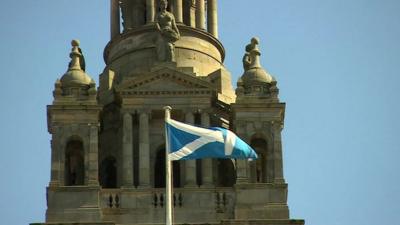 Scottish flag in front of building