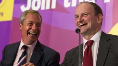 Former British Conservative Party MP Douglas Carswell (R) addresses a press conference in central London on August 28, 2014, with UKIP Party leader Nigel Farage (L)