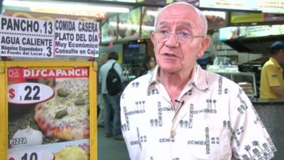 The owner of "Discapanch" at the entrance of the restaurant