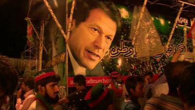 Imran Khan's face on the side of a vehicle at the protest