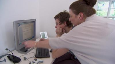 Robert Bailey and his mother using a computer