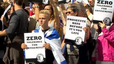 Members of the Campaign against Anti-Semitism carrying banners calling for prosecution of anti-Semites