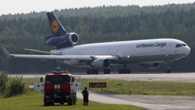 A McDonnell-Douglas MD-11 jet of Lufthansa Cargo AG taxis along the tarmac of Yemelyanovo airport, on its way to Frankfurt from Shanghai, outside Russias Siberian city of Krasnoyarsk August 16, 2014. Lufthansa Cargo AG use the Krasnoyarsk airport as the transit airport for fuelling and maintenance on its long-distance flights to and out of Europe