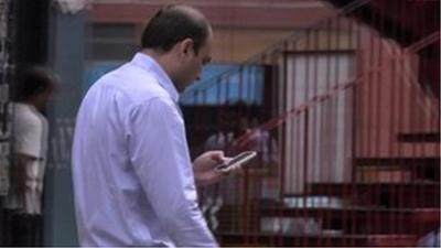 Man checking mobile phone