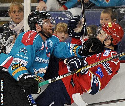 Darryl Lloyd of the Belfast Giants puts a big hit on Edinburgh Capitals opponent Callum Boyd