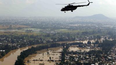 In this photograph released by the Indian Air Force, a chopper flies over flood-affected Srinagar in Indian-controlled Kashmir