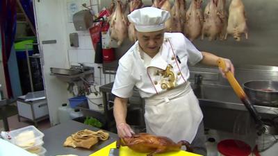 Chef preparing duck in restaurant