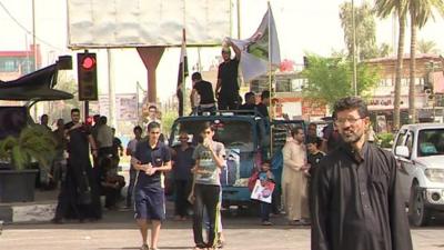 Men standing on truck with flag