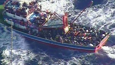 Fishing trawler overloaded with people in the Mediterranean Sea