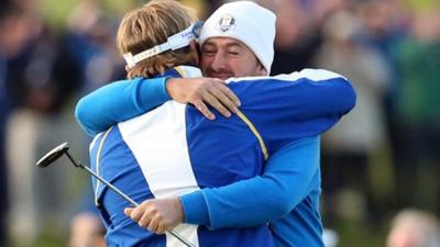 Victor Dubuisson and Graeme McDowell embrace after their foursomes victory