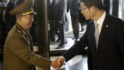 Hwang Pyong-so, left, is greeted by South Korean minister Ryoo Kihl-jae in Incheon, South Korea - 4 October 2014