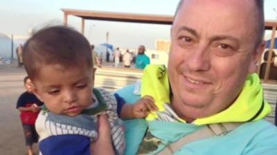 Alan Henning with child