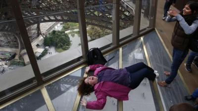 Woman on Eiffel Tower glass floor