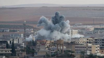 A picture taken from Turkey shows smoke rising after an airstrike by an alleged alliance war plane targeting the Islamic State in the west of Kobane