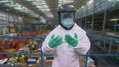 BBC reporter Danny Savage wears a protective Ebola suit