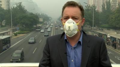 Martin Patience wearinga gas mask in Beijing