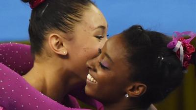 World champion Simone Biles (r) is congratulated by third-placed Kyla Ross