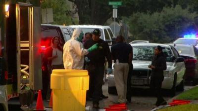 Emergency teams outside Ebola victim's home