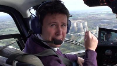 BBC reporter Jon Kay above Didcot power station