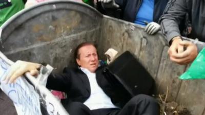 Politician in waste bin