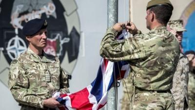 The last Union flag of Great Britain flying above the skies of Helmand Province, Afghanistan, is lowered