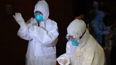 Philippine health workers don personal protective equipment (PPE) suits during training by hospital management personnel regarding the Ebola virus at the Research Institute for Tropical Medicine in Alabang town in Manila on October 28, 2014