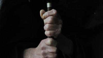 Elderly person holding cane