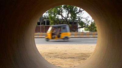 Rickshaw through a concrete pipe