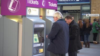 Commuters at a ticket machine