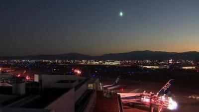 green light in sky over airport