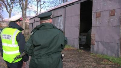 Customs and police officer at shed