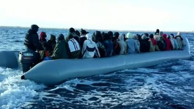 Migrants in boat in May - handout from Libyan coastguard