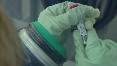 Gloves and blood sample at Ebola treatment center