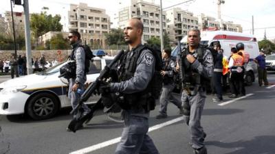 Israeli police officers walk at the scene of an attack in Jerusalem