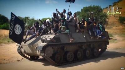 Still from Boko Haram video shows Boko Haram fighters parading on a tank