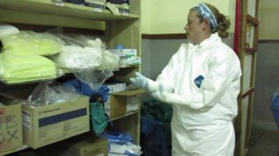 Dr Stacey Mearns puts on her protective clothing