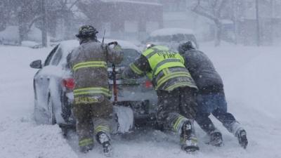 Men pushing a car in New York state