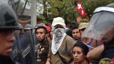 People marching near riot police