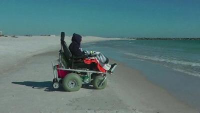 100-year-old Ruby Holt in her chair watching the ocean waves