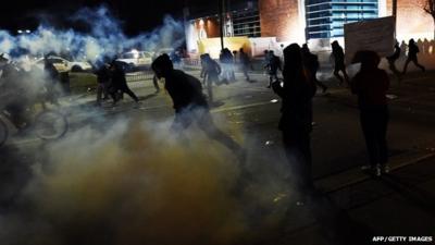 Demonstrators flee as police fire tear gas during clashes in Ferguson